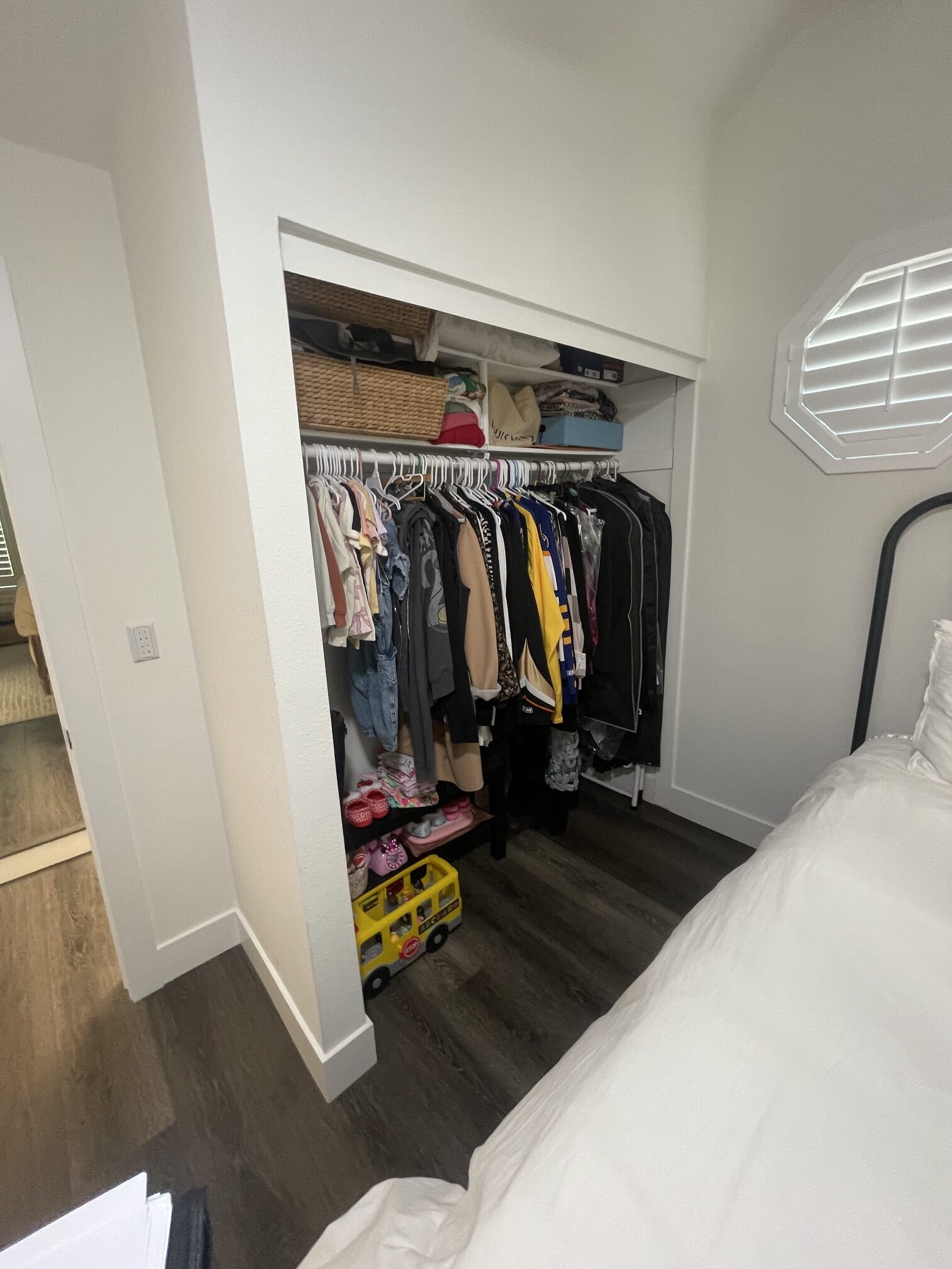 Before: reach-in closet before new doors in a Tustin bedroom
