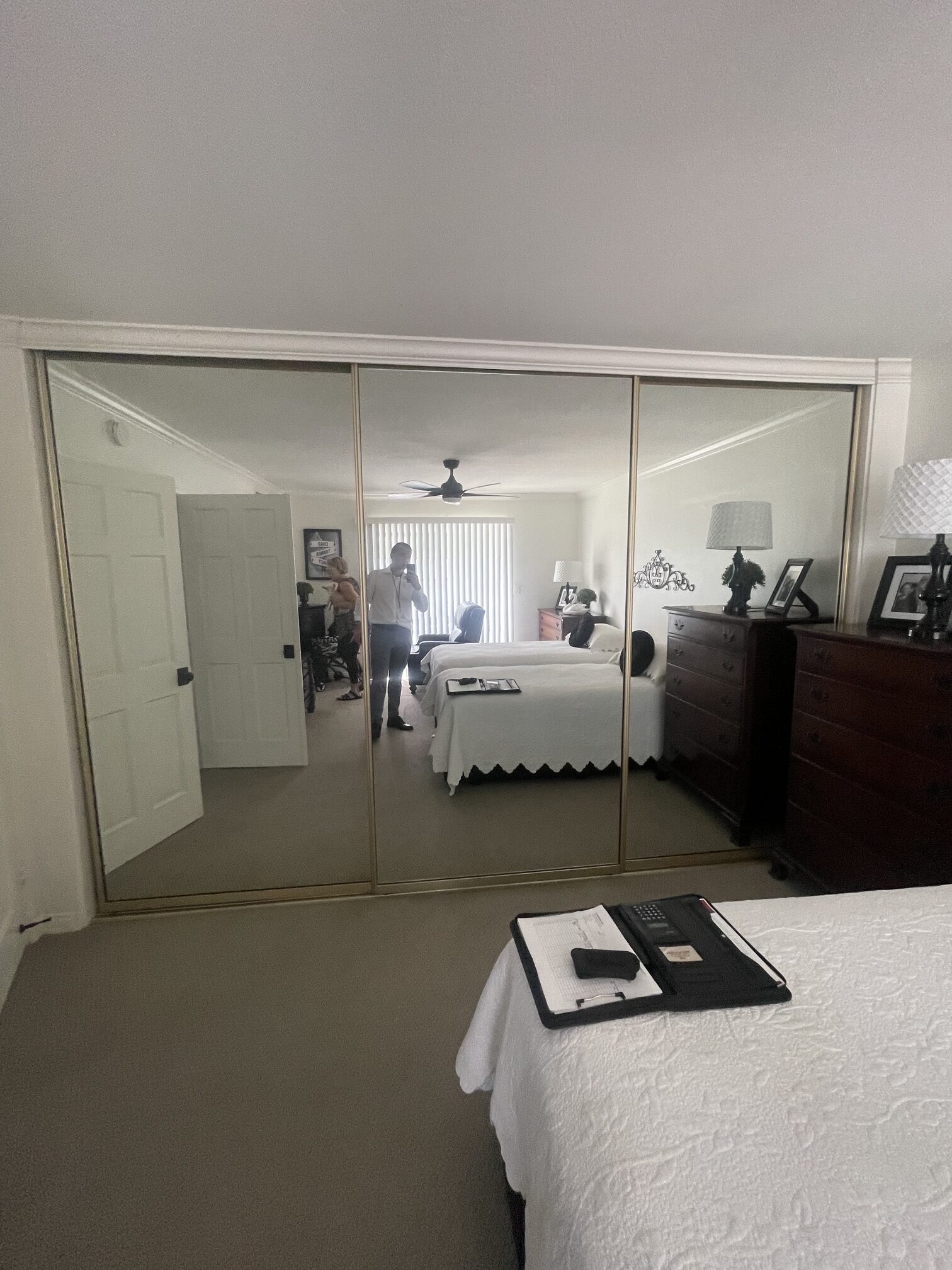 Before: older mirror closet doors in a Huntington Beach bedroom