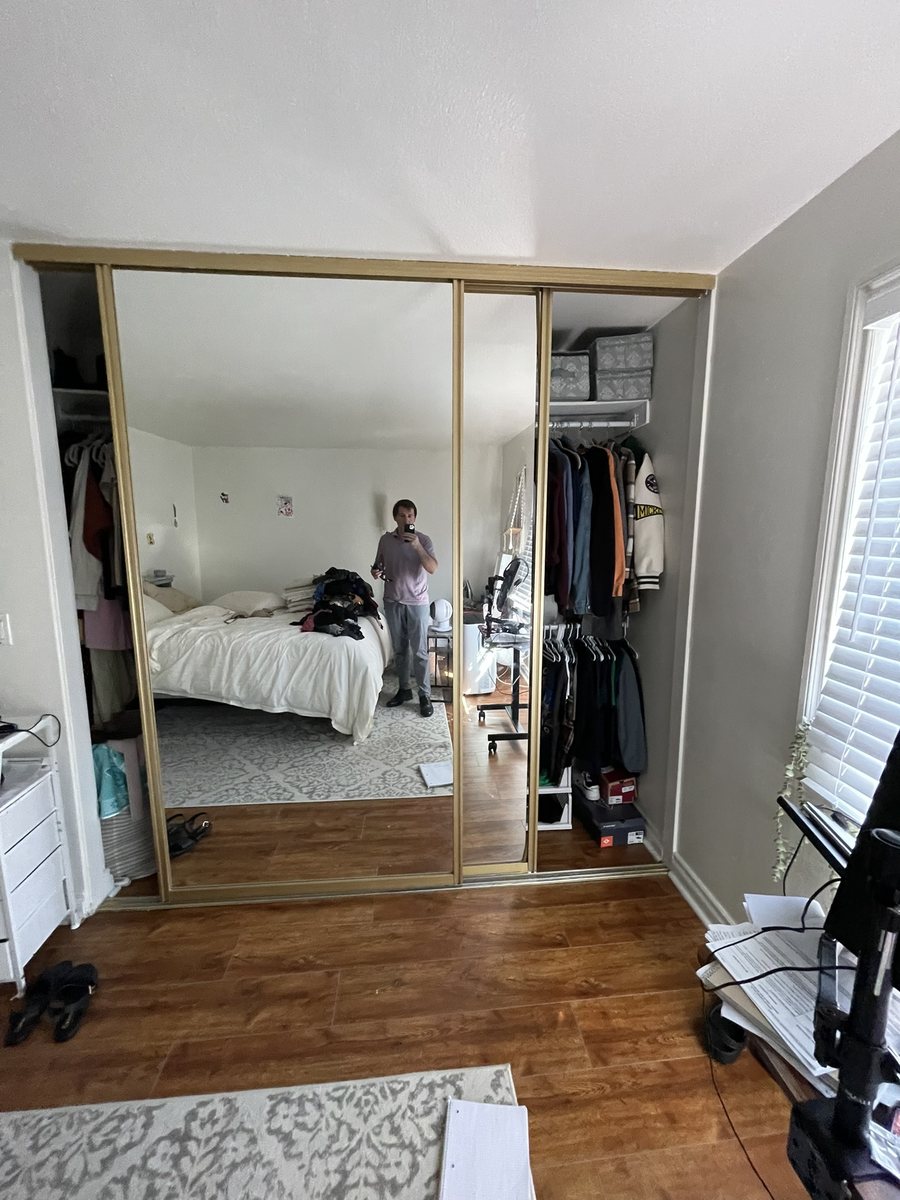 Gold frame mirror closet doors installed by The Door Replacement Company
