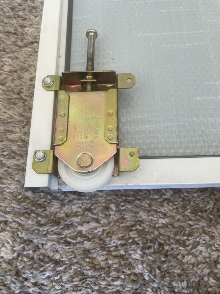 New closet door roller installed during a repair by The Door Replacement Company