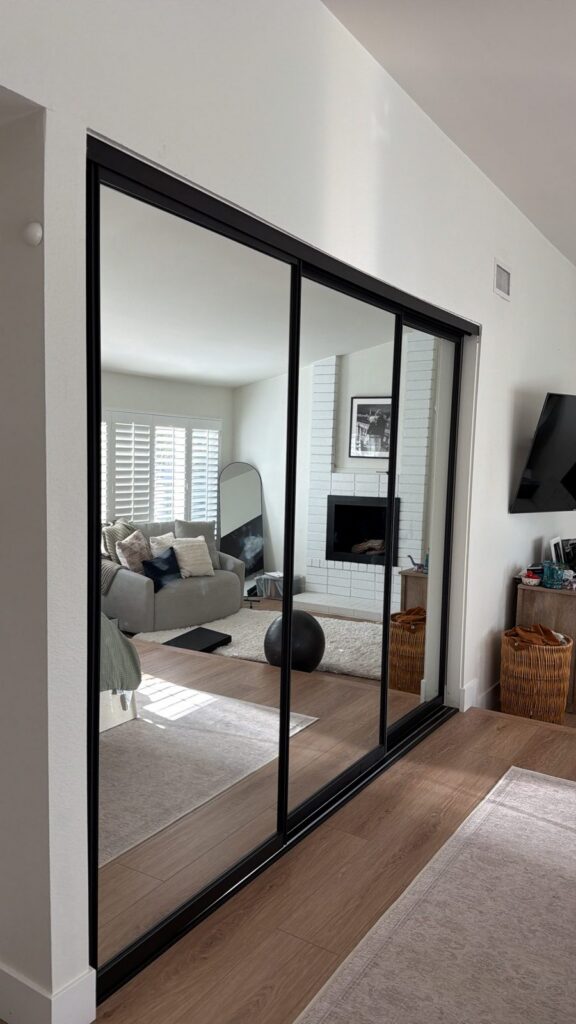 Black-frame mirror sliding closet doors installed by The Door Replacement Company, serving Irvine, CA