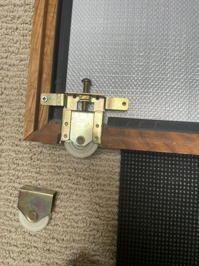 New roller installed on a sliding closet door, broken old roller beside it, Laguna Niguel, CA