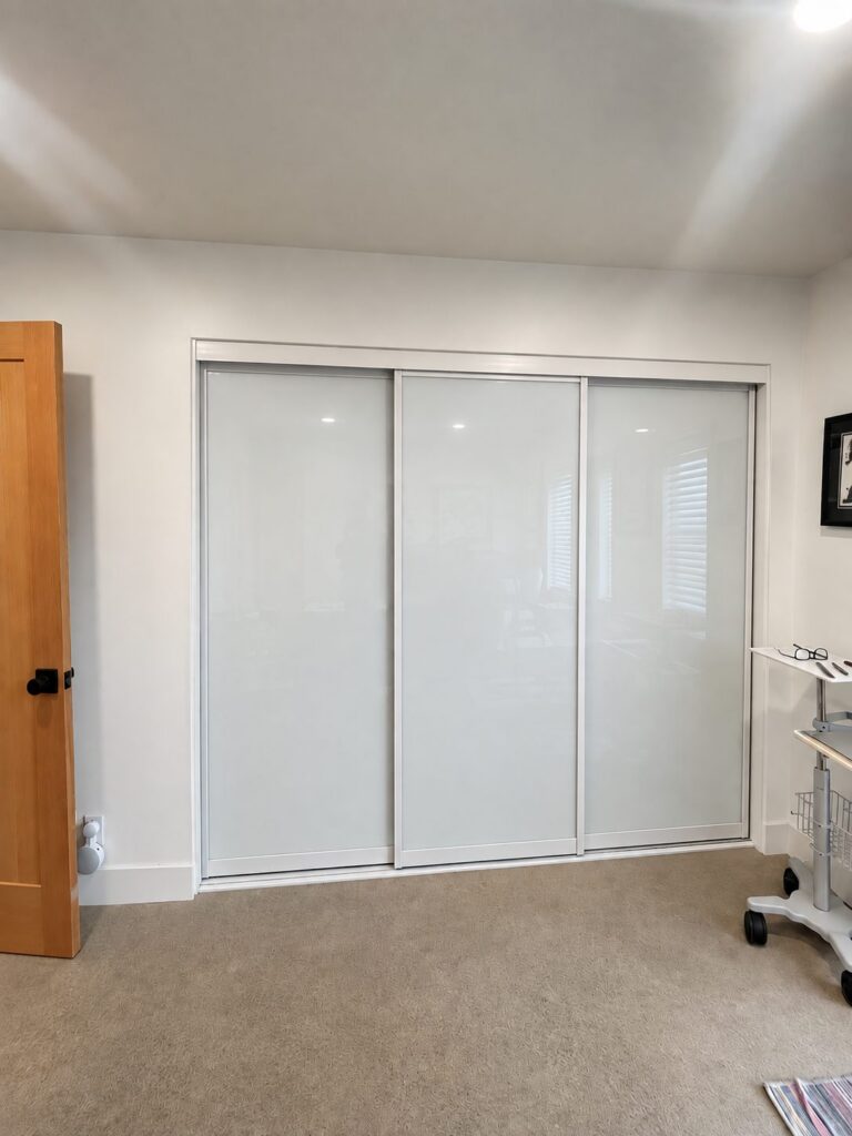 White glass sliding closet doors installed by The Door Replacement Company, serving Torrance, CA